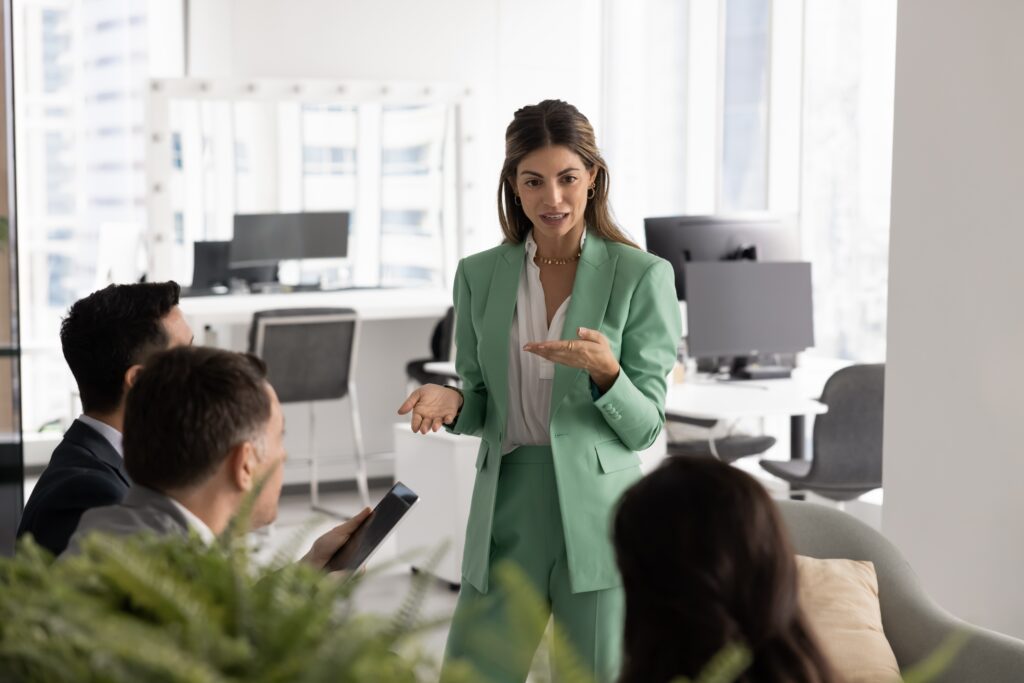 A young business professional confidently leading a team meeting