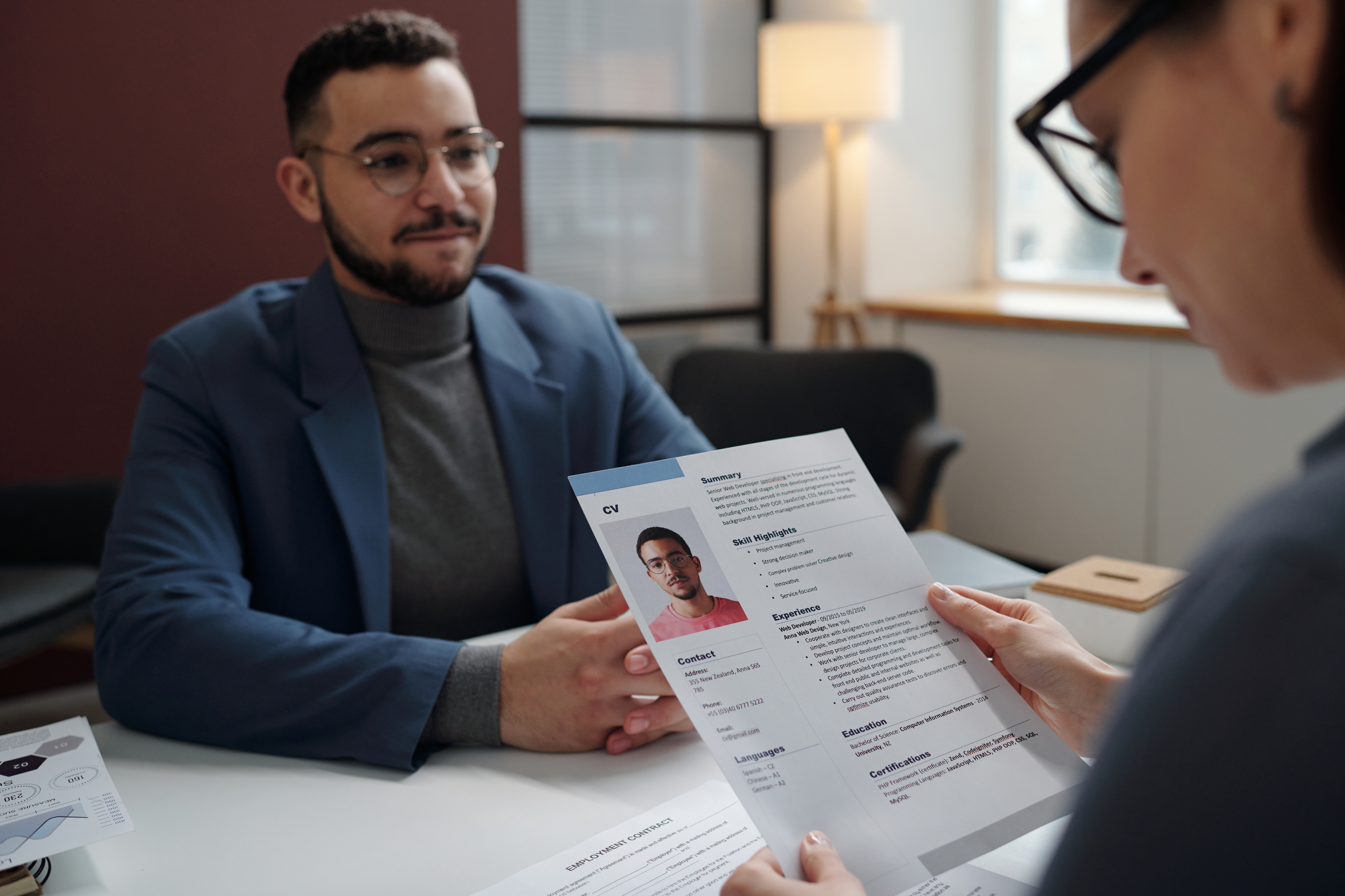 A job applicant presenting his resume to a hiring manager in person.